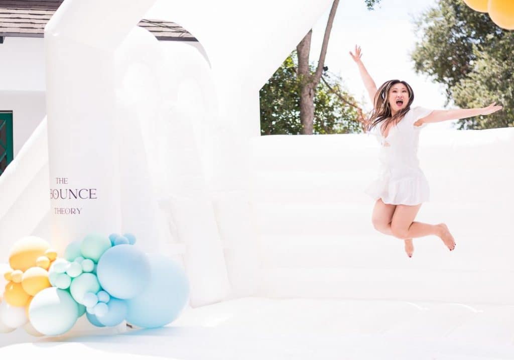 Modern White Bounce House With Slide and Balloon Garland