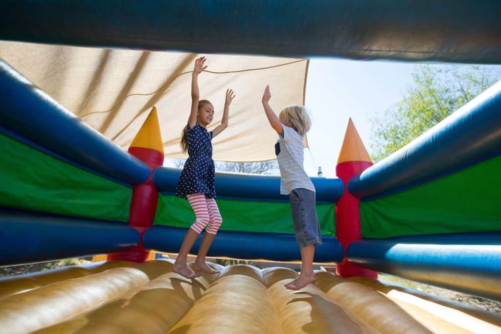 Children playing in a toddler bounce house.