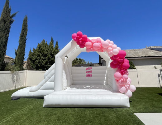 White Bounce House Rental with Pink Balloons
